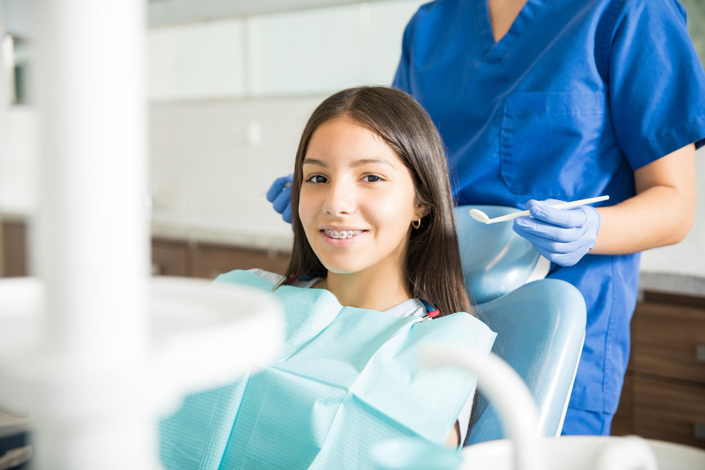 smiling teenage girl at dental clinic